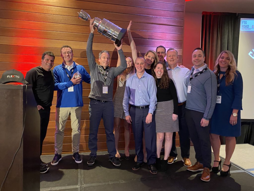 The FTG 2019 Chairman's Cup winner FlexPrint employees hoist the 2019 Chairman's Cup